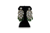 Close up of large polki kundan drop earrings with emerald green crystal fringe - green variant