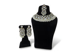 Polki kundan wedding choker necklace set with large earrings tikka and pearl bead fringe on black display stand