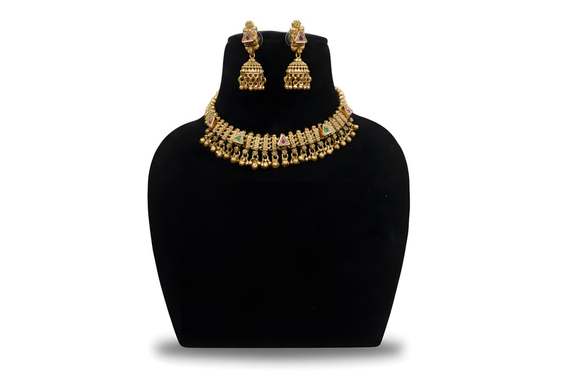 Antique gold kundan choker necklace set with jhumka earrings and ghungroo drops on black display stand