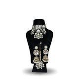 Polki kundan wedding choker necklace set with four tier jhumka earrings tikka and pearl drops on black display stand