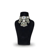 Polki kundan wedding choker necklace with pearl drops on black display stand