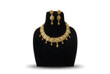 Gold plated filigree flower choker necklace set with drop earrings and gold ball drops on black display stand