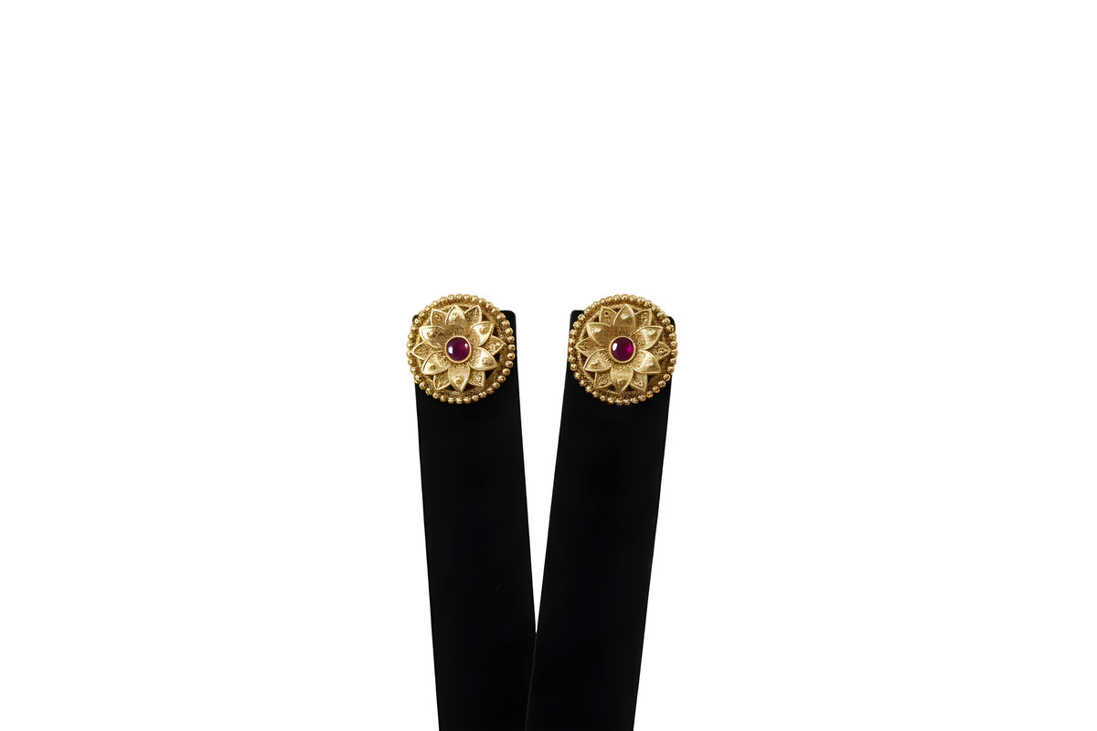 Close up of gold plated lotus petal stud earrings with ruby cabochon centre and beaded border - Jewellery by Aman
