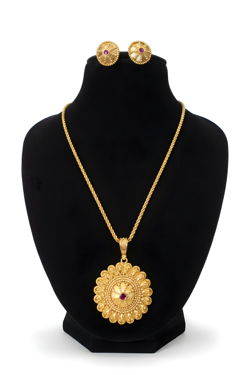 Gold plated filigree medallion pendant necklace with twisted rope chain and matching textured stud earrings on black display