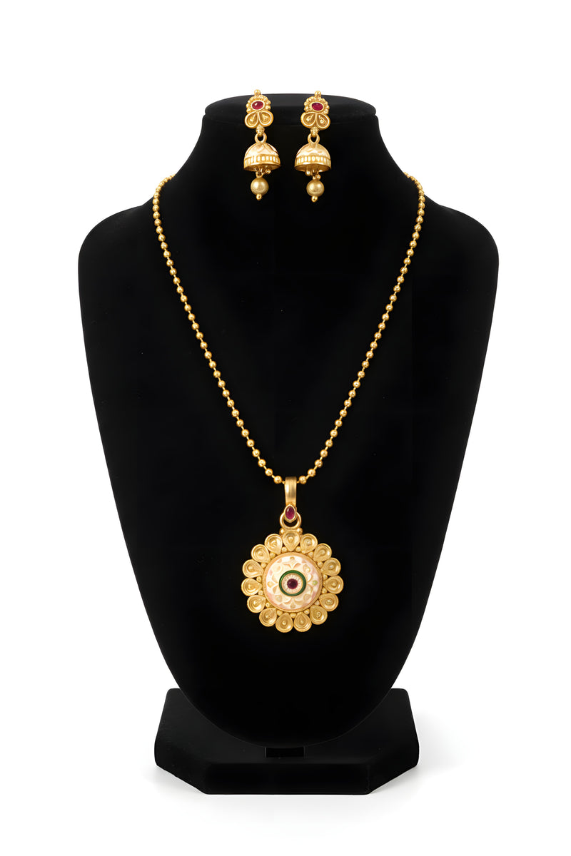 Gold plated meenakari medallion pendant necklace with ball chain and matching jhumka earrings on black display