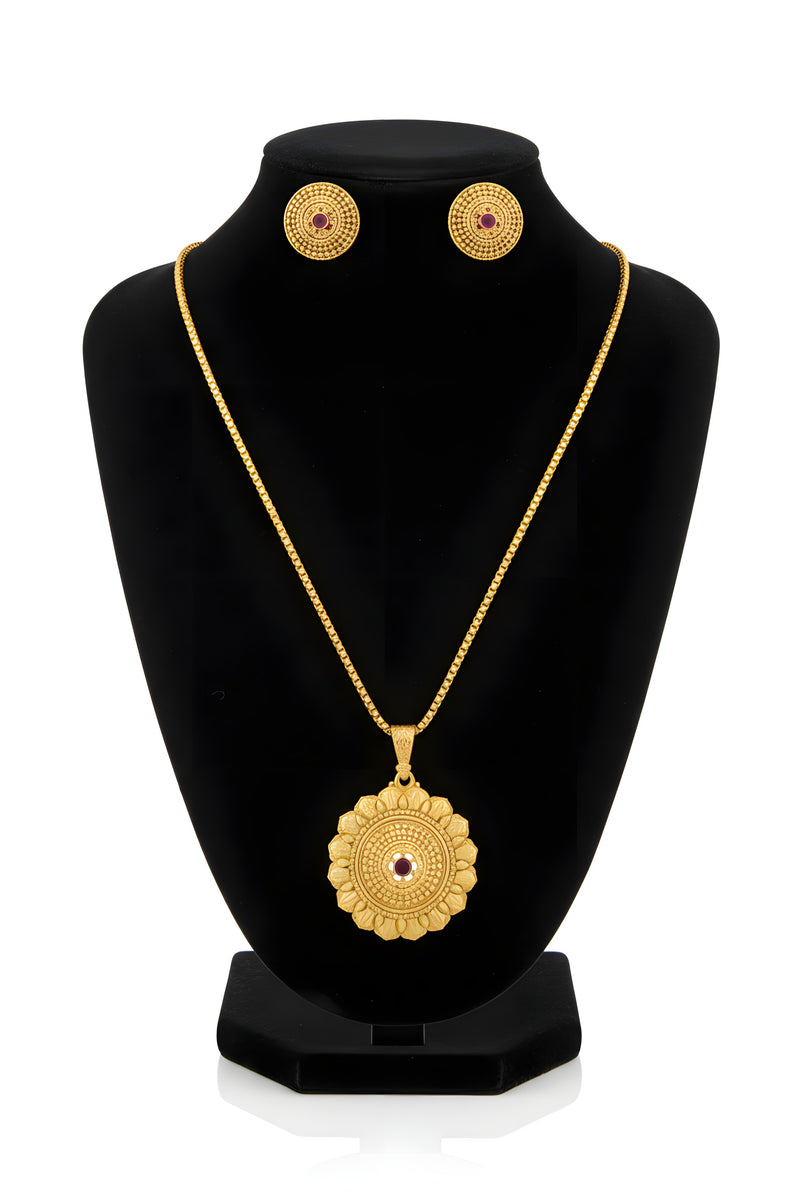 Gold plated oval medallion pendant necklace and matching ruby centre granulation stud earrings on black velvet bust