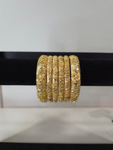 Gulbadan Rose Carved Kada Set — set of 6 thick gold kada bangles with dimensional carved rose motifs and granulation detailing