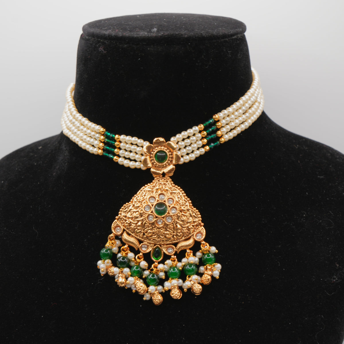 Mahira Emerald Pearl-Strand Set — gold plated pearl strand choker with triangular temple pendant with emerald stones, matching chandbali earrings and triangular maang tikka
