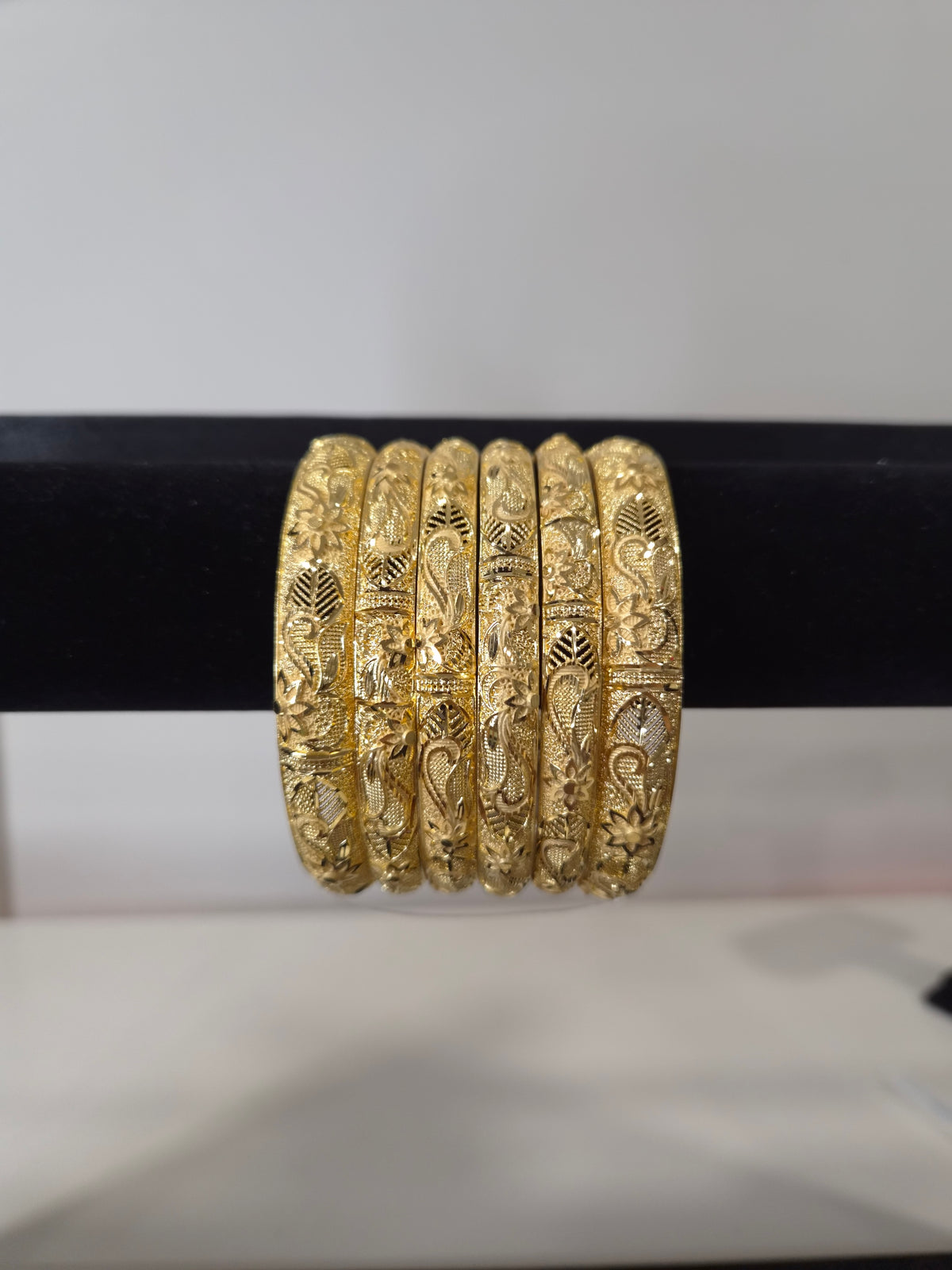 Nakshi Paisley Engraved Kada Set — set of 6 gold kada bangles with hand-engraved floral and paisley motifs and diamond-cut detailing